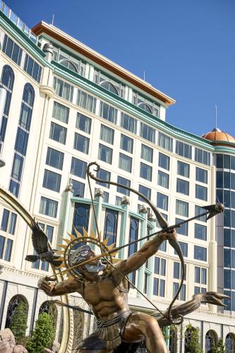 a statue in front of a large building at Universal Helios Grand Hotel, a Loews Hotel in Orlando