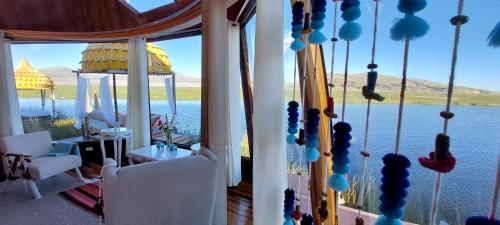 a room with a window with a view of the water at Uros Lodge Perú in Puno