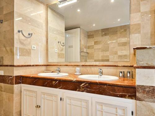 a bathroom with two sinks and a large mirror at La Cala Golf Resort Luxury appartment in Mijas