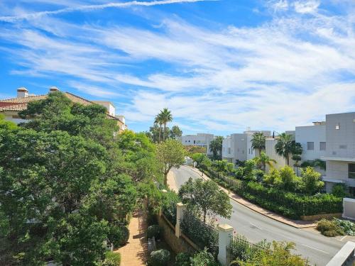 a view of a street with trees and buildings at La Cala Golf Resort Luxury appartment in Mijas