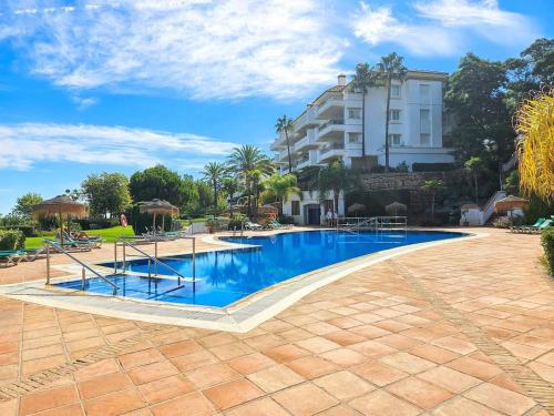 a large swimming pool in front of a building at La Cala Golf Resort Luxury appartment in Mijas
