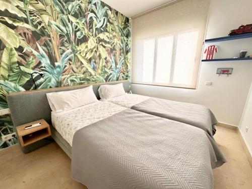 a bedroom with two beds and a mural at La Cala Golf Resort Luxury appartment in Mijas