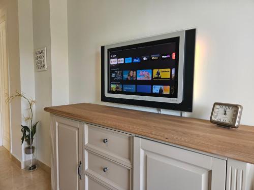 a flat screen tv sitting on top of a counter at La Cala Golf Resort Luxury appartment in Mijas