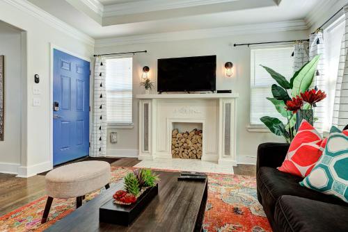 a living room with a couch and a fireplace at Gatewood Getaway-City card 4 local biz discounts in Oklahoma City