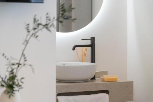 a bathroom with a sink and a mirror at La Caleta QE Hotels in Cádiz