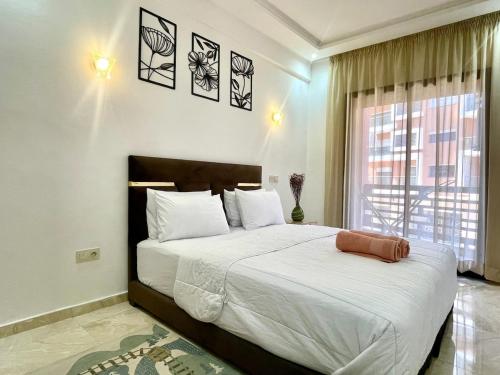 a bedroom with a large bed and a window at Luxury Aprt 2 bedrooms Pool Gueliz City Centre in Marrakech