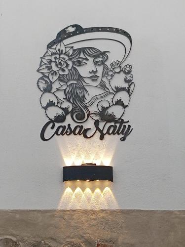 a sign for a casa salsa ally on a wall at Casa Naty in Mexico City