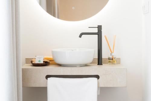 a bathroom with a sink and a mirror at La Caleta QE Hotels in Cádiz