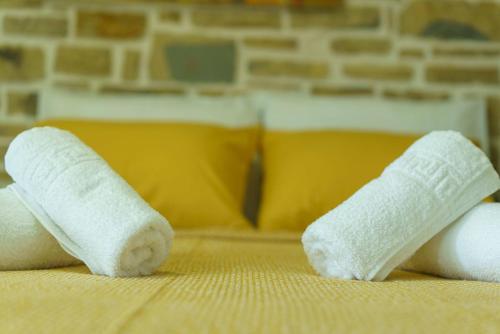 two rolled up white socks on top of a bed at Bellus Residence 2! in Ambeloúzos