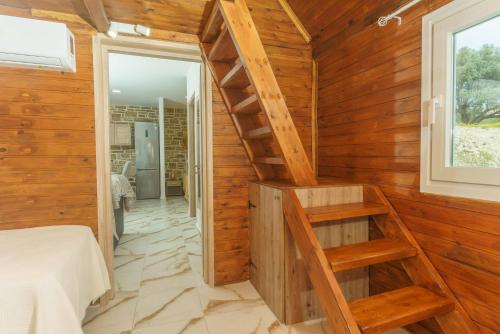 a room with a staircase in a wooden wall at Bellus Residence 2! in Ambeloúzos