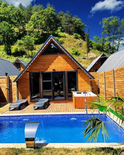 a house with a swimming pool in front of a house at Sapanca Ravine Bungalow in Sapanca