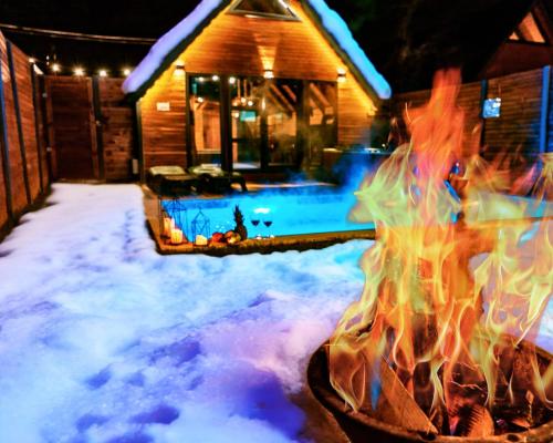 a fire pit in the snow in front of a house at Sapanca Ravine Bungalow in Sapanca