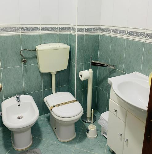 a bathroom with a toilet and a sink at SwordFish City Center Apartment in Peniche