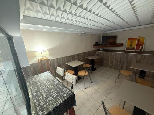 a restaurant with two tables and chairs and a table at Hotel Canciller in Mar del Plata