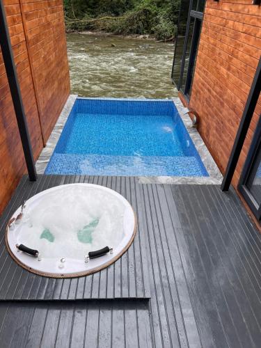 a hot tub on a deck next to a swimming pool at VALLEY SUiT OTEL in Rize