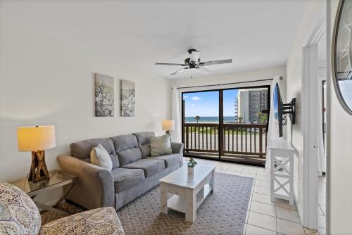 a living room with a couch and a table at Lei Lani Minit Tower Unit 219 in Orange Beach