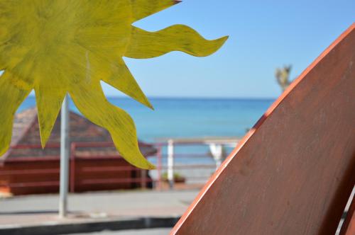 a painting of a yellow bird on a wooden fence at Hotel Piccolo Paradiso in Bordighera