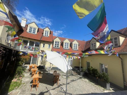 a courtyard with tables and an umbrella and flags at Norling Guest House in Vienna