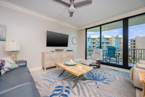 a living room with a couch and a tv at Phoenix on the Bay 1310 condo in Orange Beach