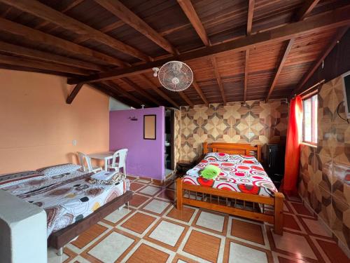 a bedroom with two beds in a room at Hotel del Parque Támesis in Támesis