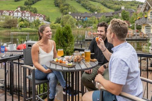 a group of people sitting around a table eating food at Blue Mountain Resort Home Collection in Blue Mountains