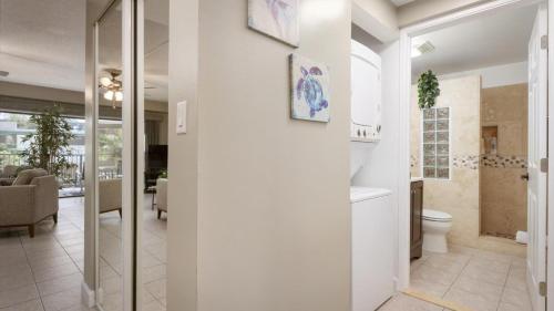 a bathroom with a toilet and a sink at Hale Lopaka at Kona Plaza in Kailua-Kona