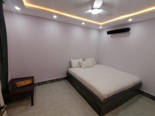 a small bedroom with a bed and a table at Mount Murree Hotel in Murree