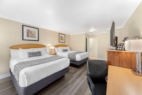 a hotel room with two beds and a desk at Best Western Plus Ontario Airport & Convention Center in Ontario