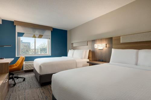 a hotel room with two beds and a window at Holiday Inn Express Baltimore At The Stadiums by IHG in Baltimore