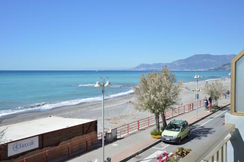 a view of a beach with a car parked on the street at Hotel Piccolo Paradiso in Bordighera
