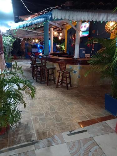 a bar in a restaurant with chairs and a table at Hotel boutique in Boca Chica