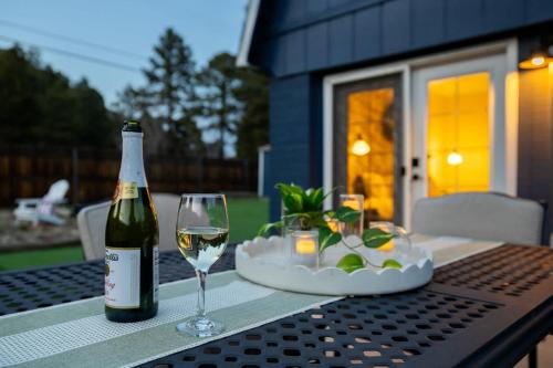 a bottle of wine and a glass on a table at Relaxing Mountain Haven by Nature's Doorstep in Flagstaff