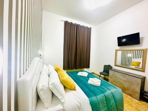 a bedroom with a white bed with yellow pillows at Rome Termini Down-town Accommodation in Rome