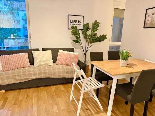 a living room with a couch and a table at Modern Apartment with Balcony near SCS in Wiener Neudorf