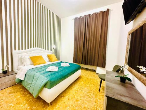 a bedroom with a bed with colorful sheets and a window at Rome Termini Down-town Accommodation in Rome