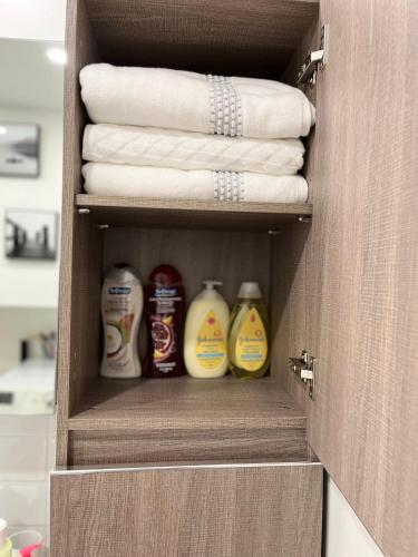 a drawer with towels and other cleaning products in a bathroom at Charming beautiful house 7mn to downtown Ottawa in Gatineau