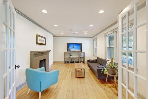 a living room with a couch and a fireplace at Delsey family home steps away from Park Circle in Charleston