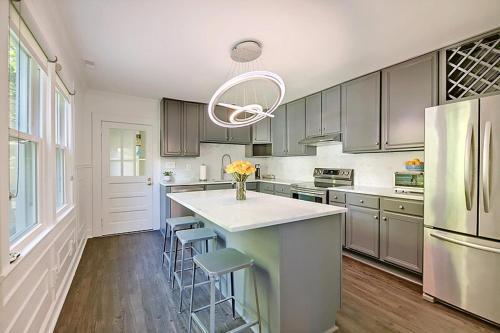 a kitchen with a white counter and a refrigerator at Delsey family home steps away from Park Circle in Charleston