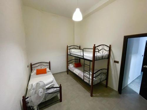 two bunk beds in a room with a mirror at Anwal apart Fibra centro 6 personas excursions in Tetouan