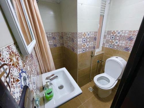 a small bathroom with a toilet and a sink at Anwal apart Fibra centro 6 personas excursions in Tetouan