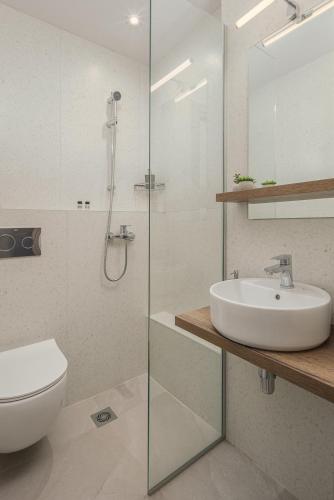 a bathroom with a sink and a toilet and a shower at Areti Guesthouse in Víssani