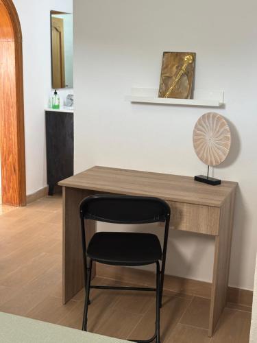a desk with a chair and a fan on it at Los Marmoles in Giniginámar