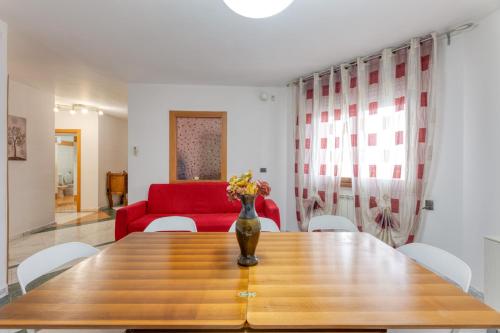 a dining room table with a vase of flowers on it at Villa Urso in Ugento