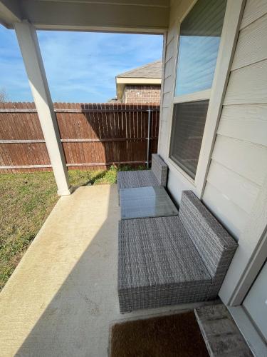 two benches on the front porch of a house at Cozy Room in a quiet house for professionals / Business Travel in Aubrey