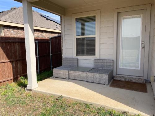 a porch with a bench next to a door at Cozy Room in a quiet house for professionals / Business Travel in Aubrey