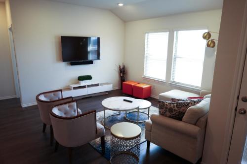 a living room with a couch and a table at Cozy Room in a quiet house for professionals / Business Travel in Aubrey