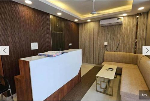 a lobby with a bar and a couch in a room at HOTEL O THE VIRAAT in Noida
