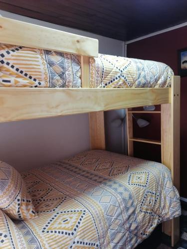 twolevel bunk beds in a room with at Casa Lo Herrera in Isla de Maipo