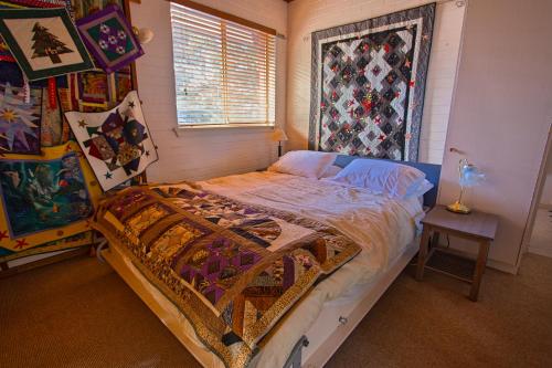 a bedroom with a bed and a window at Quilters Studio in Gawler