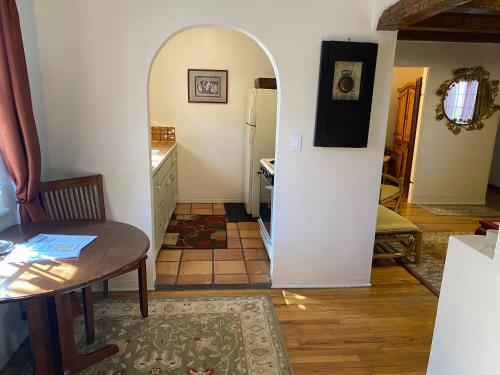 a kitchen with a table and a dining room at Casa de Tres Lunas/House of Three Moons in Santa Fe
